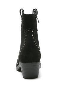 Botas de tobillo de ante negro con un tacón bajo, que presentan tachuelas plateadas decorativas a lo largo de los costados y un zipper lateral como cierre.