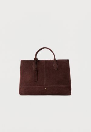 Sac à main rectangulaire en suède marron foncé avec deux poignées et un petit logo doré centré près du bas sur un fond uni.