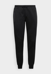 Sorte sweatpants med snor i taljen, tætsiddende ben og sidelommer med lynlås; lavet af blødt stof med subtile teksturerede detaljer.