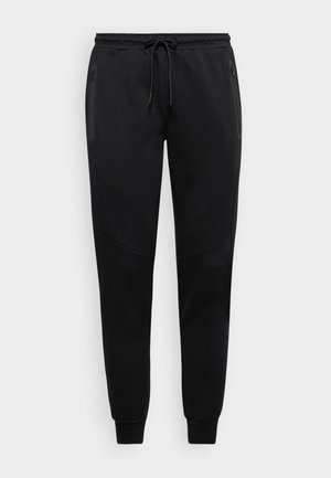 Black sweatpants with a drawstring waist, tapered legs, and side zip pockets; made of soft fabric with subtle textured detailing.