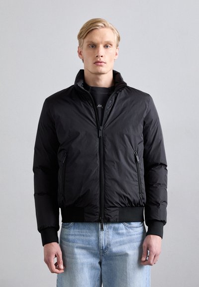 Black puffer jacket with a high collar, front zip closure, and two side pockets; features elastic cuffs and a smooth, shiny texture.