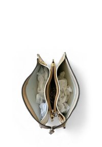 Zippered wallet in cream and gold, featuring two compartments lined with soft material and crumpled white tissue paper inside.