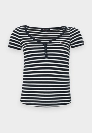 Striped short-sleeve top in navy and white ribbed fabric, featuring a V-neck, three-button placket, and a small logo detail on the chest.