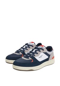Navy and gray sneakers with textile and suede materials. Features a white logo, red accents, and a textured rubber sole.
