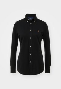 Chemise noire à manches longues avec boutons, col et petit logo brodé sur la poitrine gauche.