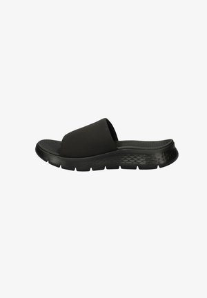 Schwarze Slip-On-Sandale mit dicker Sohle und strukturiertem Fußbett, für den lässigen Gebrauch entworfen.