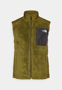 Olivgrön ärmlös väst med en plysch, strukturerad framsida och en slät baksida. Har en svart bröstficka med logotyp och en framdragkedja.