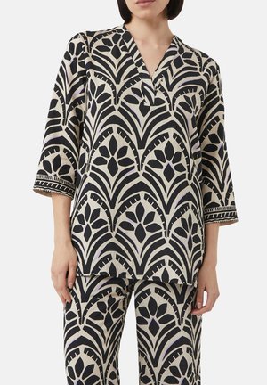 Geprinte top in crème en zwart met een V-hals, driekwartmouwen en bloemenpatronen met fijne geborduurde accenten.