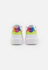 Multicolored platform sneakers with a white base, featuring textured fabric, rainbow accents on the heel, and embossed logo on the sole.