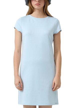 Jeune femme portant une robe à manches courtes bleu clair et un chapeau seau gris, debout les bras détendus le long du corps.