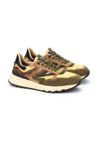 Zapatillas con una mezcla de ante y malla en amarillo, marrón y verde. Presentan acentos texturizados en negro y una suela gruesa en blanco y negro.