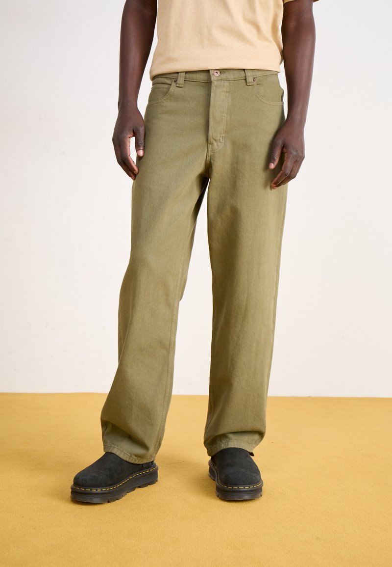 Olive green, loose-fitting pants with a straight leg, made of textured fabric, featuring a button closure and belt loops.