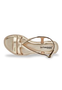 Gold leather sandal featuring cross straps, a slightly cushioned insole, and a side buckle closure. Label reads "Les Tropéziennes par M Belarbi."