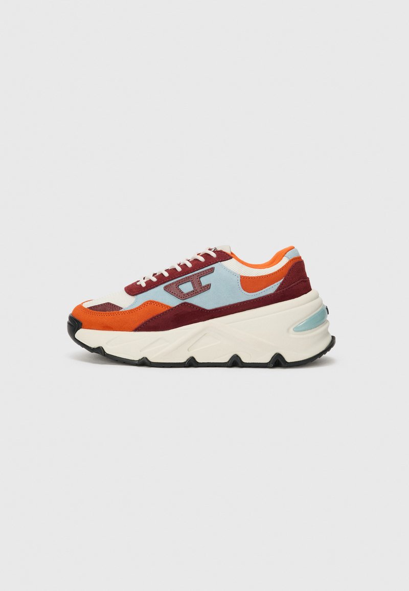 Multicolored sneakers featuring red, orange, blue, and cream panels, made from suede and mesh, with a thick white sole and black tread.