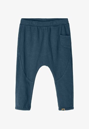 Pantalon pour tout-petit bleu foncé avec taille élastique, entrejambe tombant, jambes fuselées et petite poche plaquée sur le côté droit.