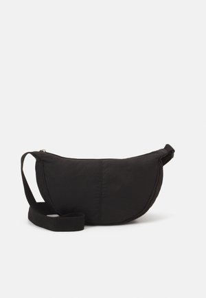 Black shoulder bag with a rounded silhouette. Made of textured fabric, featuring a zip closure and a woven strap. Simple, minimal design.