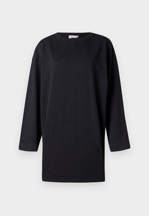 T-shirt noir à manches longues en coton, avec un col rond et des fentes sur les côtés, au fit décontracté et au design minimal.