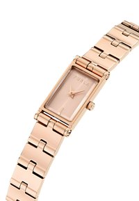 Orologio rettangolare in oro rosa con un quadrante minimalista, caratterizzato da delicate marcature delle ore, un cinturino metallico con segmenti collegati e un dettaglio sulla corona.
