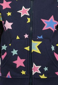 Felpa con zip blu navy decorata con un motivo a stelle in rosa, giallo, blu e menta, dotata di una tasca frontale e di un tessuto testurizzato.