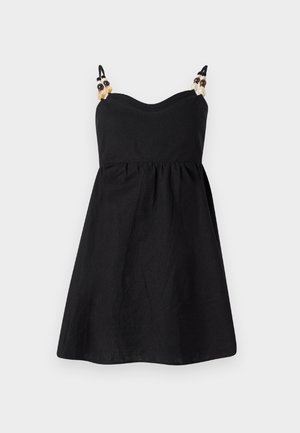 Black linen dress with a fitted bodice and flared skirt. Slim straps adorned with decorative beads at the shoulders. Smooth texture.