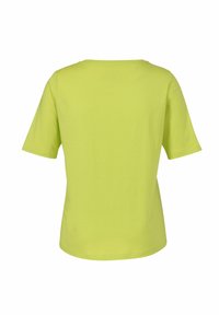 Korte mouw, ronde hals T-shirt in levendig limoen groen katoen. Heeft een soepele textuur met een ontspannen pasvorm en een eenvoudig ontwerp.