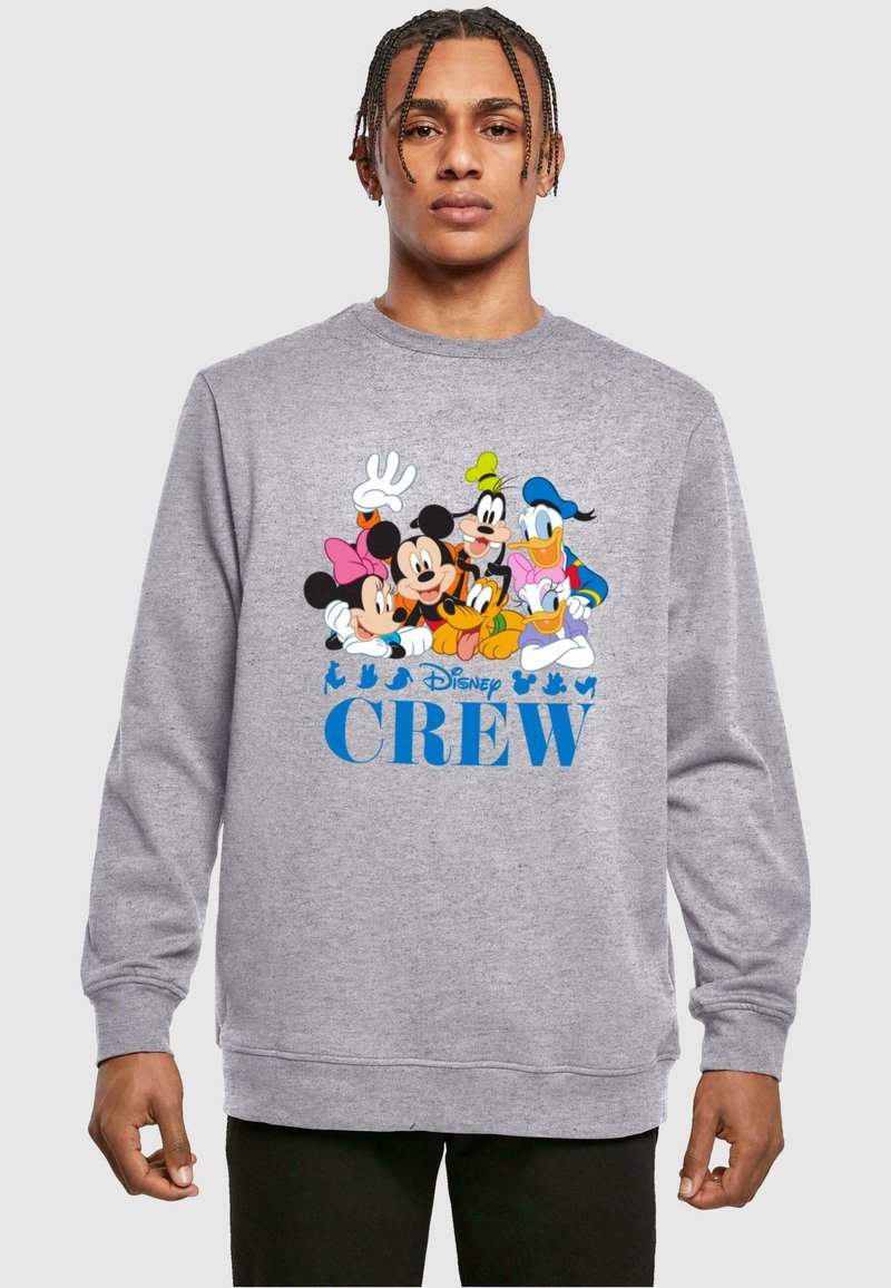 Felpa grigia a girocollo con grafiche colorate di personaggi Disney, tra cui Mickey, Minnie, Donald e Goofy. Il testo recita "Disney CREW."