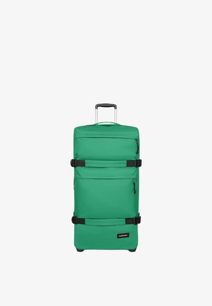 Valise verte à roulettes avec poignée extensible, deux sangles de compression noires, poches avant zippées et logo Eastpak sur le panneau inférieur avant.
