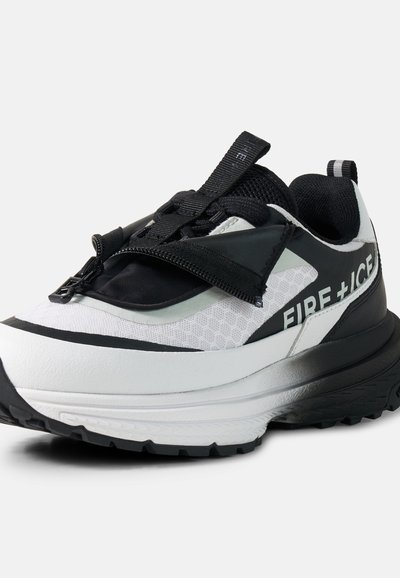 Baskets blanches et noires avec une semelle épaisse, détail zip sur les lacets et marquage "FIRE + ICE" sur le côté.