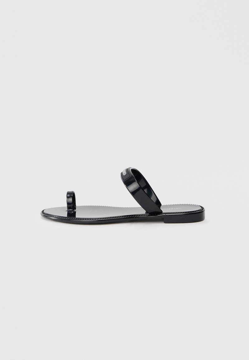 Black flat sandals with a smooth, glossy finish. Features a toe post and two slender straps. Minimalist design with a flat sole.