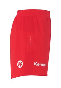 Rode sportieve shorts van ademend materiaal. Voorzien van een elastische tailleband, zijzak en een wit "Kempa"-logo met tekstdetail.