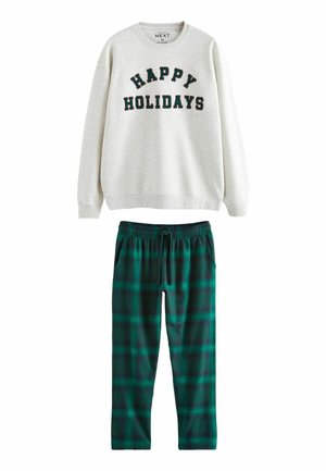 Grauer Sweatshirt mit der Aufschrift "FROHE FEIERTAGE" in schwarzer Schrift. Grüne Karohosen aus Schlafanzug mit elastischem Bund und Seitentaschen.