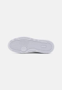White rubber sneaker sole with a tread pattern featuring zigzag textures and circular accents. Smooth finish with embedded brand logo.
