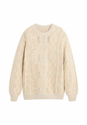 Kremine megzta megztinis su sudėtingais pynimo ir nėrinių raštais, ribotais rankogaliais, apačia ir apvalia iškirpte.