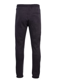 Schwarze Jogginghose mit elastischem Bund, Slim-Fit-Schnitt und gerafften Knöchelbündchen. Besitzt eine einzelne Gesäßtasche. Weicher, strukturierter Stoff.