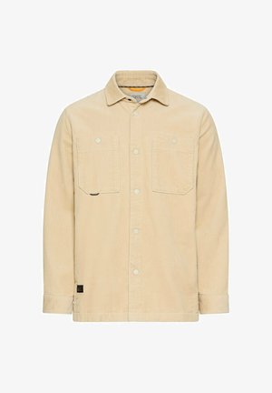 Beige corduroy knoopjacket met twee borstzakken, een kraag en lange mouwen.