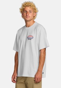 Camiseta de algodón blanca con un gráfico colorido de medusa en el pecho. Mangas cortas, corte relajado y etiqueta tejida en el dobladillo.