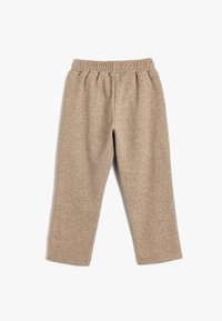Beige Jogginghose aus weichem Stoff, mit elastischem Bund und geradem Schnitt. Keine sichtbaren Muster oder Hardware-Details.