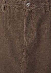 Brown corduroy trousers with vertical ribbing, featuring a silver button at the waist and stitched detailing along the seams.