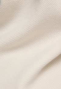 Beige textured fabric with a ribbed pattern, featuring a soft and smooth surface. Subtle sheen enhances the material's appearance.