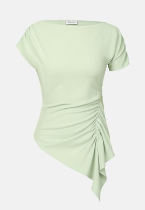 Light green, short-sleeve top with a draped design, ruched side detailing, and asymmetrical hem. Made from a smooth, stretchy material.