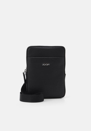 Black leather crossbody bag with textured surface, zip closure, and a detachable fabric strap. Features a silver logo on the front.