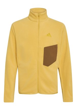 Žlutá fleecová bunda na zip s vysokým límcem, hnědým texturovaným náprsním kapsou a jemným žlutým logem na levé straně hrudi.