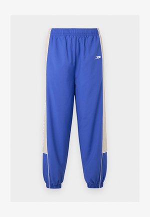 Niebieskie spodnie sportowe z beżowymi bocznymi panelami, elastyczną talią i mankietami przy kostkach, z małym białym logo na górnej części uda.