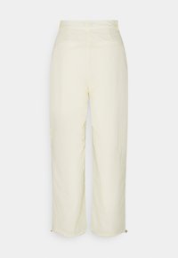 Lichtgele wijde broek met een soepele textuur, voorzien van twee achterzakken en ritsaccenten aan de zoom. Middenhoogte tailleontwerp.