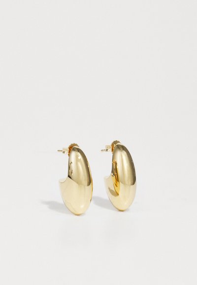 Gold hoop earrings featuring a smooth, rounded design with a reflective surface and a secure clasp closure.