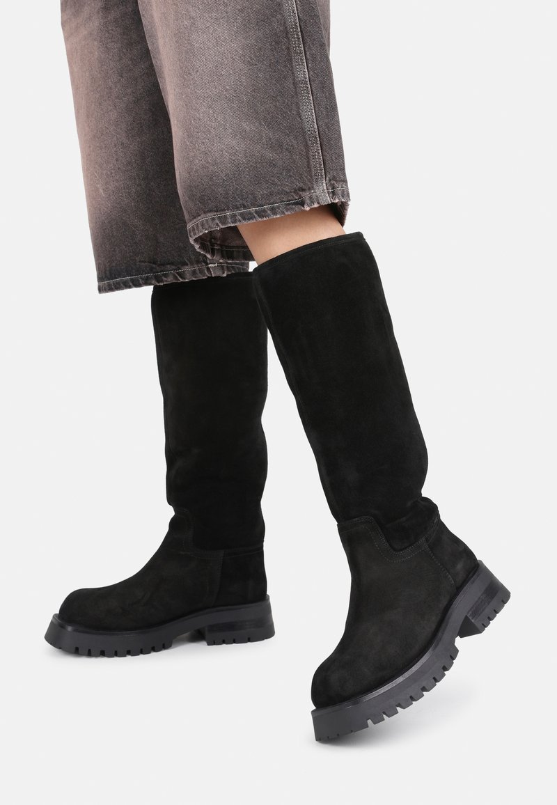 Black suede knee-high boots with a chunky black rubber sole. Features a rounded toe and smooth, seamless upper design.