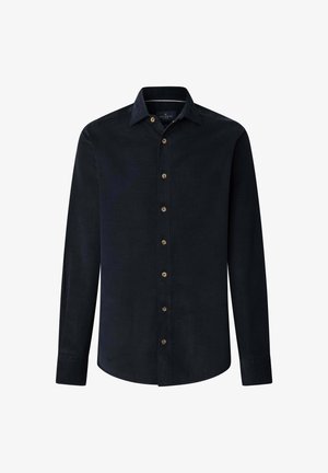 Pitkähihaisessa tummansinisessä corduroy-paidassa on napillinen kaulus ja kuusi ruskeaa nappia edessä. Sileä tekstuuri.