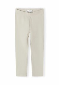 Krämfärgade ribbade stickade leggings med resårmidja, designade för barn, liggande platt på en vit bakgrund.