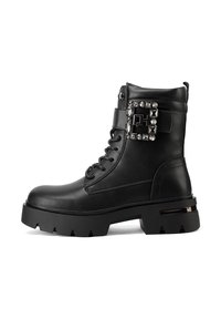 Stivali alla caviglia in pelle nera con suola massiccia, design con lacci, hardware decorativo sul lato e texture liscia. Punta quadrata e tacco robusto.