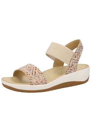 Sandales compensées beiges avec dessus texturé orné de petites taches multicolores, une large bande élastique et une semelle blanche avec une base marron.